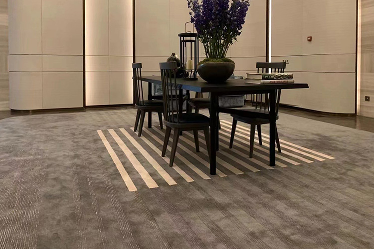 A large square premium bespoke hand tufted carpet with bold straight lines, installed in a modern meeting room