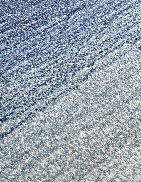 Tufted rug with gradient cut pile texture transitioning from deep navy to light blue, creating a flowing watercolor effect