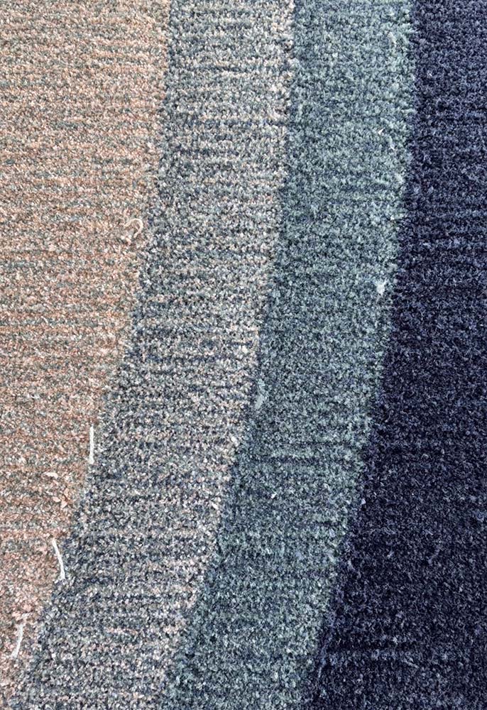 Vertical bands of bespoke tufted rug yarn textures in beige, gray, and navy shades