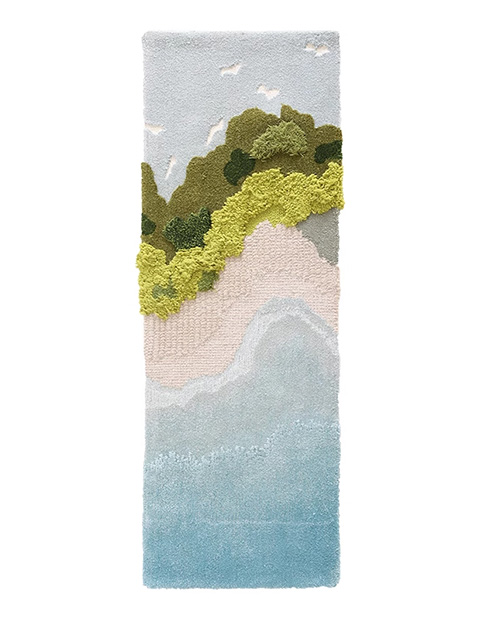 Long rectangular tufted moss rug showing layered beach scene with ocean, sandy shore, moss cliffs, and small seabirds against gray sky