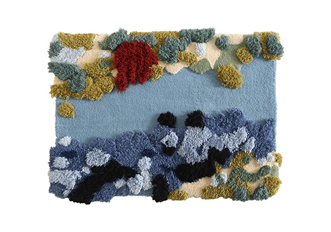 Square tufted rug showing seascape with sky blue waters, dark rocky outcrops, and mossy shoreline