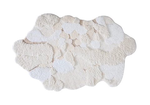 Cloud-shaped tufted rug in textured white and off-white tones, mimicking fresh snow patches with gentle shadows